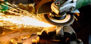 Angle grinder cutting scrap metal with sparks