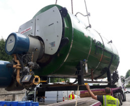 Green Boiler being loaded on to flatbed lorry