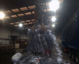 Crane lifting household wire in warehouse