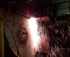 Old tank being cut up with angle grinder